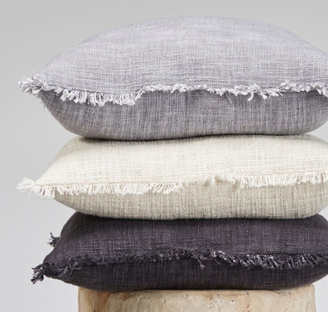 Fringed cushion covers, stacked